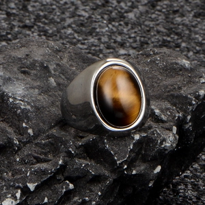 Polished stainless steel ring for men featuring a large oval tiger eye gemstone