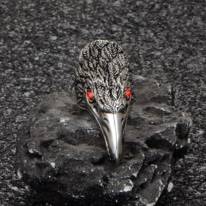 Vintage gothic bird head ring in stainless steel with red zircon eyes on black rock