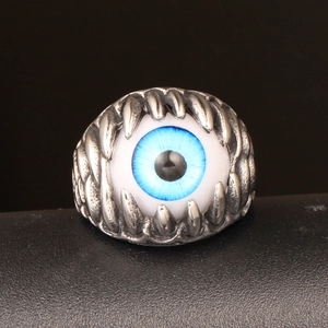 Gothic stainless steel ring featuring a blue evil eye stone held by sharp dragon claws