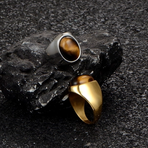 Tiger eye stone rings for men in gold and silver steel finishes on black rock