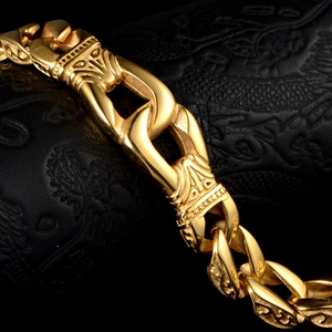 Macro shot of gold titanium steel bracelet featuring intricate tribal vintage engravings
