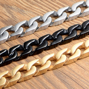 Titanium steel cuban link bracelets in matte silver, black and gold on wood surface