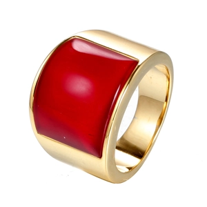 Polished gold wide band ring featuring a square red cabochon stone on white background