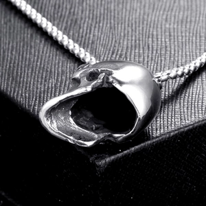 Polished stainless steel skull pendant necklace with box chain on black background