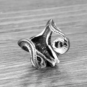 Vintage stainless steel ram head ring with intricate relief engraving and aged metal finish