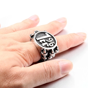 Macro shot of punk style steel ring featuring 1%er engraving and vintage finish