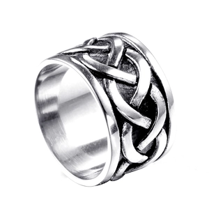Detail of vintage silver wide band ring with intricate Celtic knot relief and polished inner