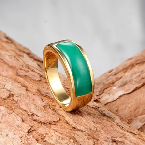 Detailed close-up of a wide gold stainless steel ring featuring a rectangular green stone