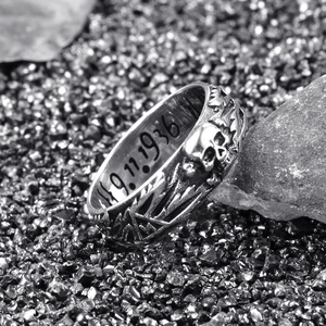 Macro shot of punk skull ring with 9.11.1936 engraving and vintage silver relief