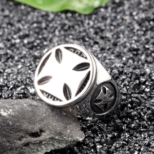 Macro shot of stainless steel cross ring with vintage embossed gothic patterns