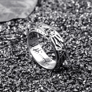 Macro view of vintage silver punk skull ring with feather textures and inner engraving