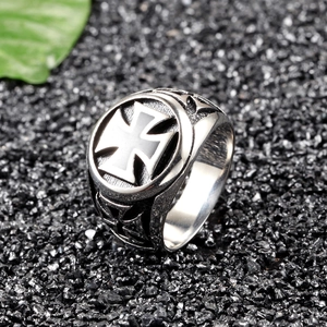 Close-up of vintage stainless steel biker ring featuring engraved Maltese crosses