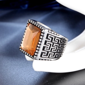 Vintage stainless steel ring with orange gemstone and geometric engraving pattern
