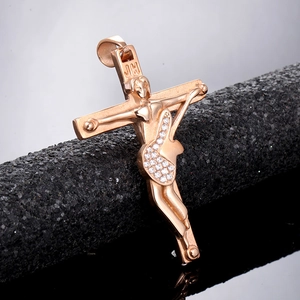 Macro shot of rose gold guitar cross pendant with sparkling white zircons on black stand