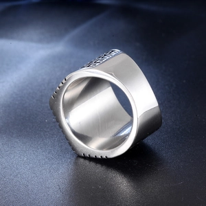 Macro detail of silver stainless steel signet ring featuring geometric engraved textures