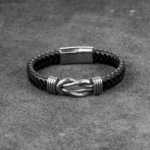 Men's black braided leather bracelet featuring a silver infinity charm and magnetic clasp
