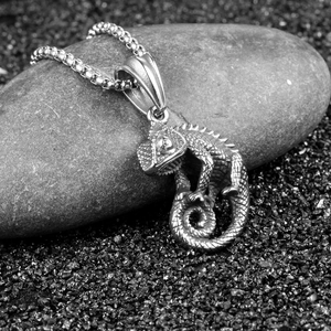 Retro stainless steel chameleon pendant necklace with detailed scales on a grey stone
