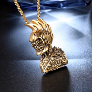Detailed close-up of punk mohawk skull pendant in gold finish with sturdy box chain