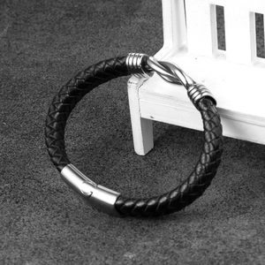 Detail of multi-strand black braided leather bracelet with stainless steel magnetic clasp