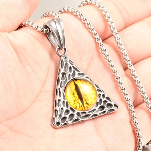 Close-up of hip hop dragon eye triangle pendant with amber pupil on box chain