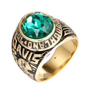 Golden American football championship ring with large green gemstone and rugby helmet relief