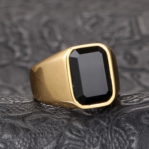 Men's polished gold plated ring featuring a large rectangular black onyx gemstone inlay