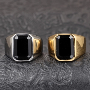 Macro detail of men's wide titanium steel rings with square emerald-cut black agate stones