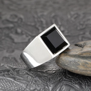 Détail d'une bague punk vintage en acier titane pour homme avec une grande pierre noire