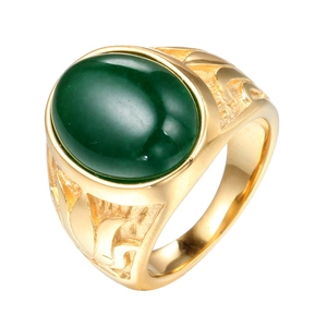 Gold plated stainless steel ring with large oval green gemstone on a white background
