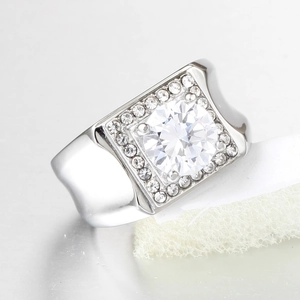 Macro shot of silver men's titanium ring with large round zircon and geometric diamond halo