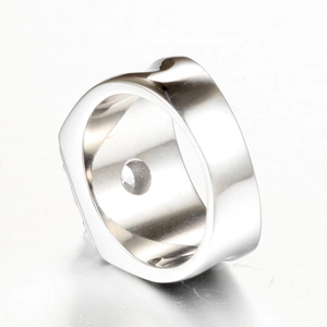 Macro detail of men's titanium steel ring featuring Greek key pattern and polished finish