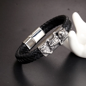 Braided black leather bracelet for men featuring a silver skull skeleton metal plate