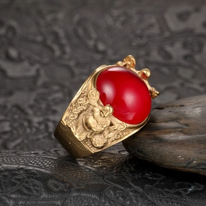 Vintage men's gold stainless steel ring featuring a large red oval gemstone and relief