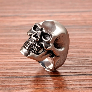 Close-up of vintage silver skull ring in stainless steel with detailed punk carvings