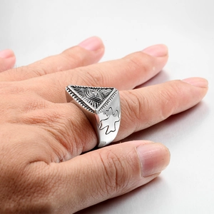 Detailed close-up of a silver eye of providence ring with vintage triangle relief