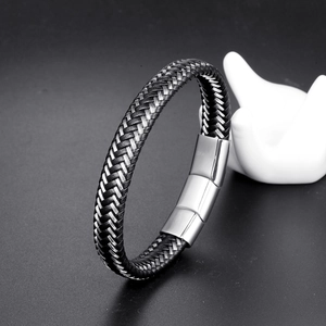 Detail shot of men's braided leather bracelet with a polished magnetic metal clasp