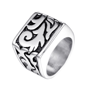 Macro view of vintage stainless steel ring showing deep embossed floral patterns