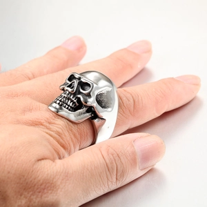 Detailed view of punk skull ring in silver stainless steel on model hand