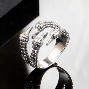 Macro shot of punk style claw ring with detailed scale texture and vintage finish