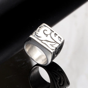 Polished silver stainless steel signet ring with engraved square pattern and reflection