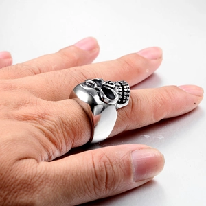 Polished stainless steel skull ring for men with intricate gothic biker details on finger