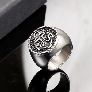 Macro shot of men's stainless steel anchor ring with vintage polished texture