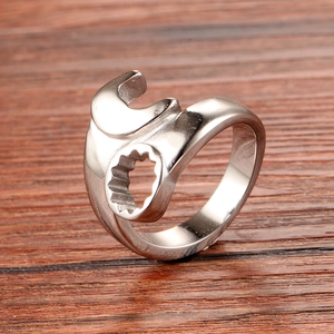 Macro shot of silver wrench ring on wood showing the detailed open and ring end tools