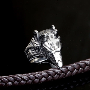 Macro shot of silver Anubis ring featuring Egyptian Ankh cross and ornate carvings