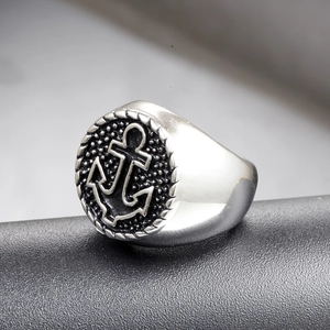 Macro detail of nautical anchor signet ring with rope border and polished steel finish