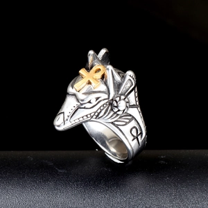 Macro view of Anubis wolf ring with golden Ankh symbol and vintage silver relief detail