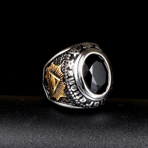 Detailed close-up of retro stainless steel signet ring with black oval gemstone and eye symbol