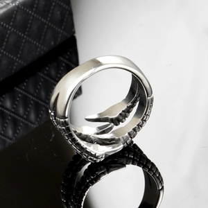 Punk style stainless steel dragon claw ring with scale texture on black reflective surface