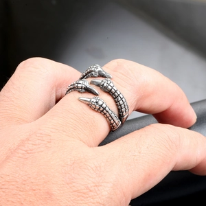 Macro shot of punk style dragon claw ring with detailed vintage silver scales