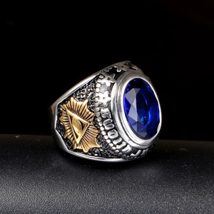 Detail of vintage seal ring with blue gemstone and gold All-Seeing Eye engraving